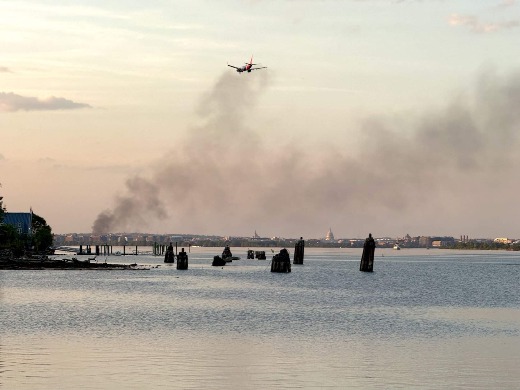 plane flies through black smoke