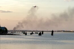 plane flies through black smoke