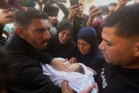 Palestinians hold funerals for pregnant woman and her children killed in Israeli strikes