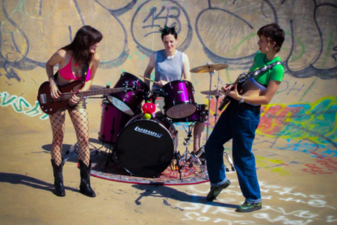 band playing with graffiti in background
