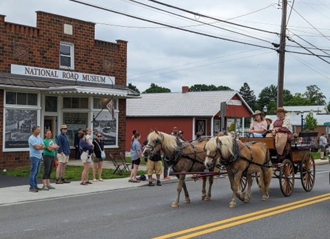 A wagon train passing in front of the National Road Museum in Boonsboro