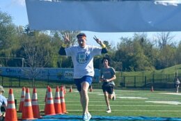 Dr. Taylor crossing the finish line