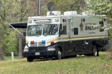 A sheriff's office command vehicle parked in a wooded area