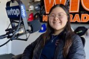 Tabitha Hyun sits at a microphone in a WTOP studio