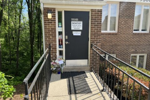 outside of a dental practice with flowers laying at the door