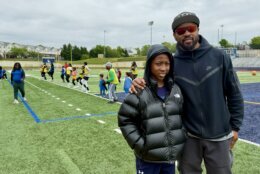 Santana Moss with a student at football clinic