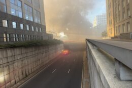 smoke fills the sky in city