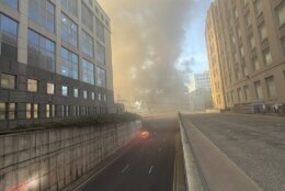 smoke fills the sky in city