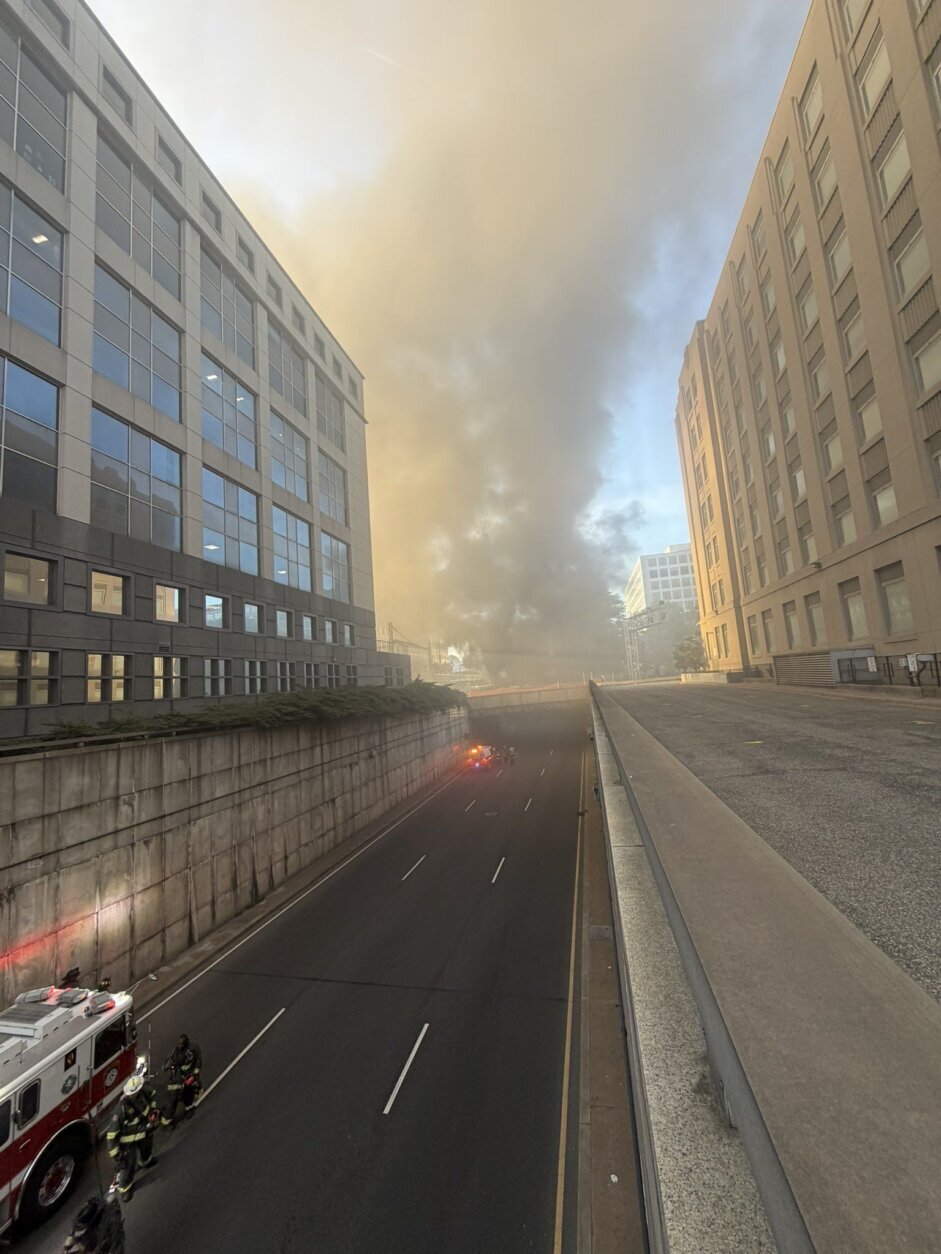 smoke fills the sky in city