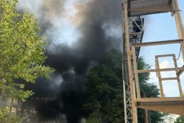 smoke fills the sky in city