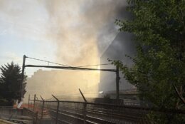 smoke fills the sky in city