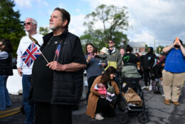 Keith Hudnall (L) waits in line for a parade and block party event on the final day of the state visit of King Charles III and Queen Camilla