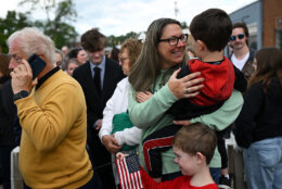 People wait in line for a parade and block party event on the final day of the state visit of King Charles III and Queen Camilla
