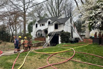 firefighters outside house with hoses after fire