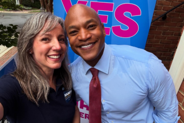 a woman and a man smile for a photo