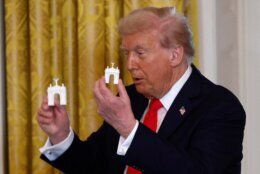A model of President Trump's proposed triumphal arch to commemorate the country's 250th anniversary was seen on the Resolute Desk as the president held a press conference with FBI Director Kash Patel and Attorney General Pam Bondi in the Oval Office on Wednesday.

The renderings and model show an arc that looks similar to France's Arc de Triomphe, built across from the Lincoln Memorial, on the Virginia side of the Potomac River in Washington, D.C.

When asked on Wednesday who the arc is for, Trump told CBS News' Ed O'Keefe: "Me."