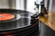 A close-up of a spinning vinyl record on a turntable,