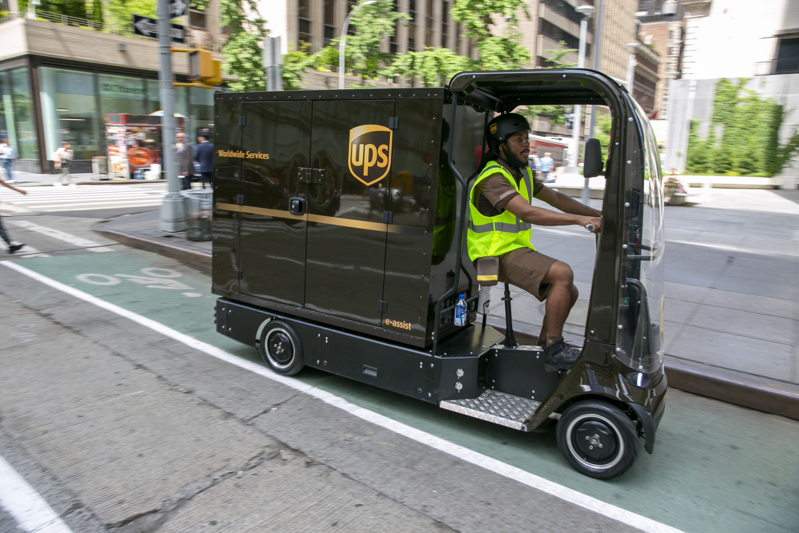 a delivery worker peddles a quad bike delivery vehicle