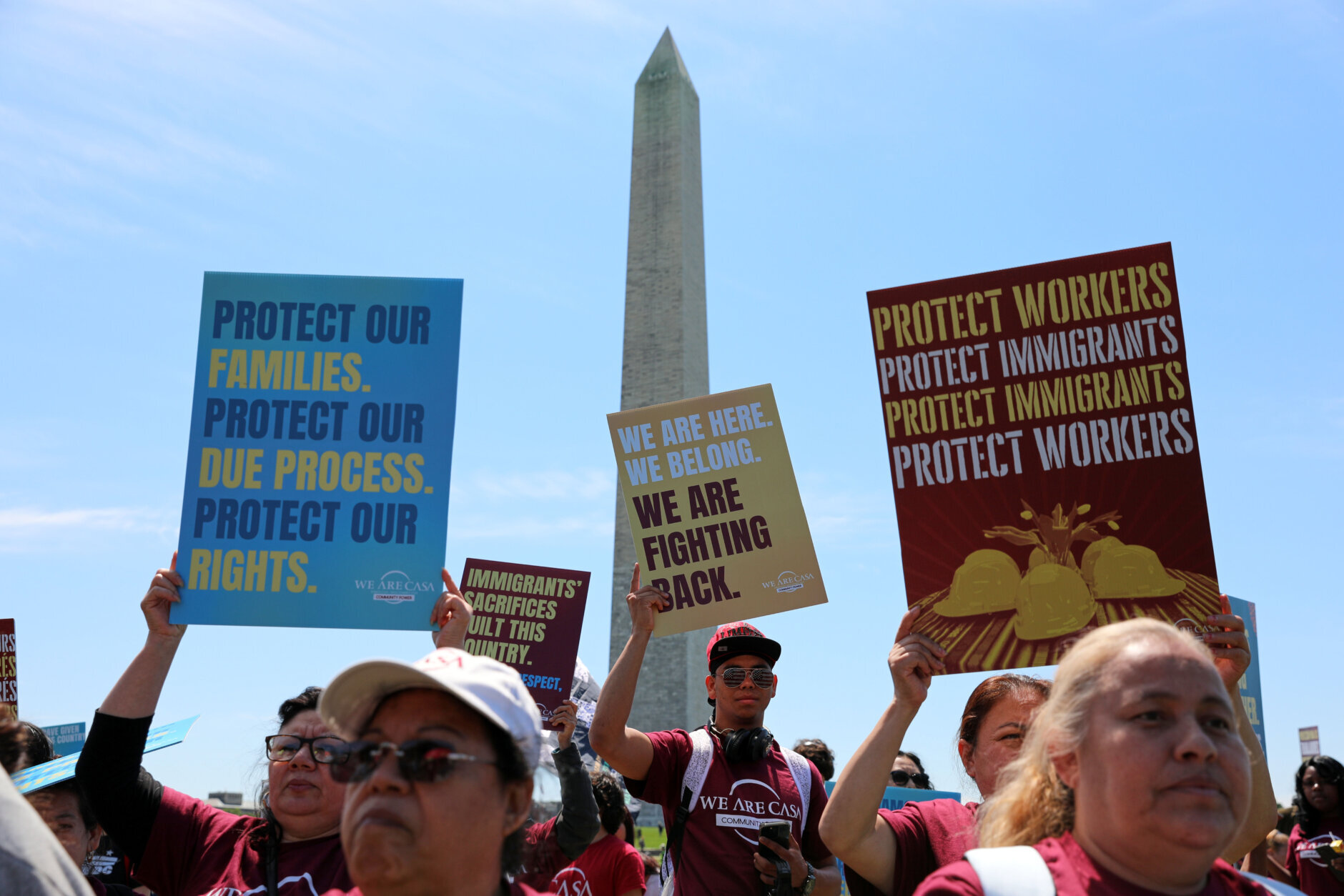 Demonstrators march as they rally at the National Mall during a May Day protest Friday, May 1, 2026, in Washington. (AP Photo/Rahmat Gul)