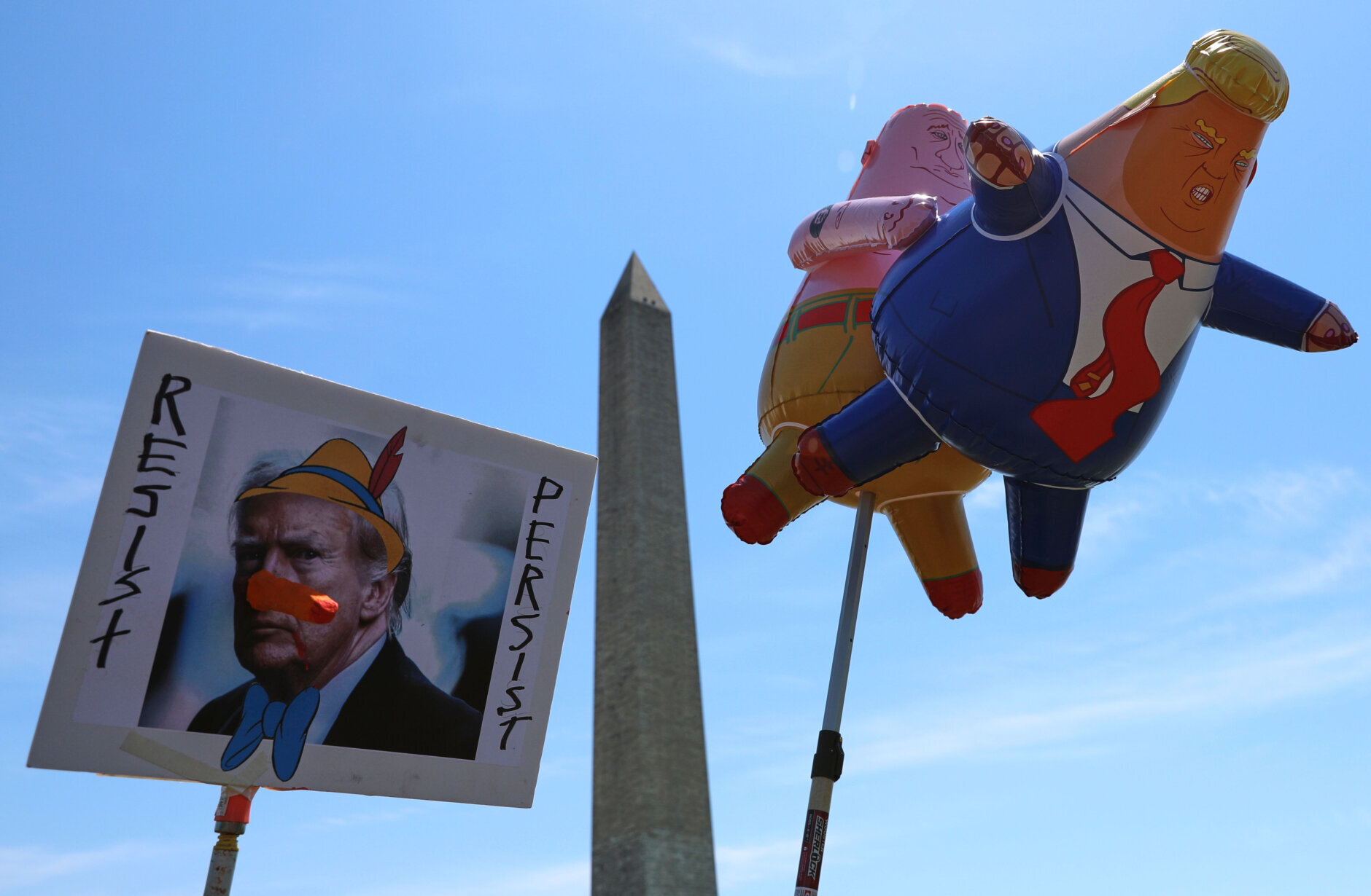 Demonstrators march as they rally at the National Mall during a May Day protest Friday, May 1, 2026, in Washington. (AP Photo/Rahmat Gul)
