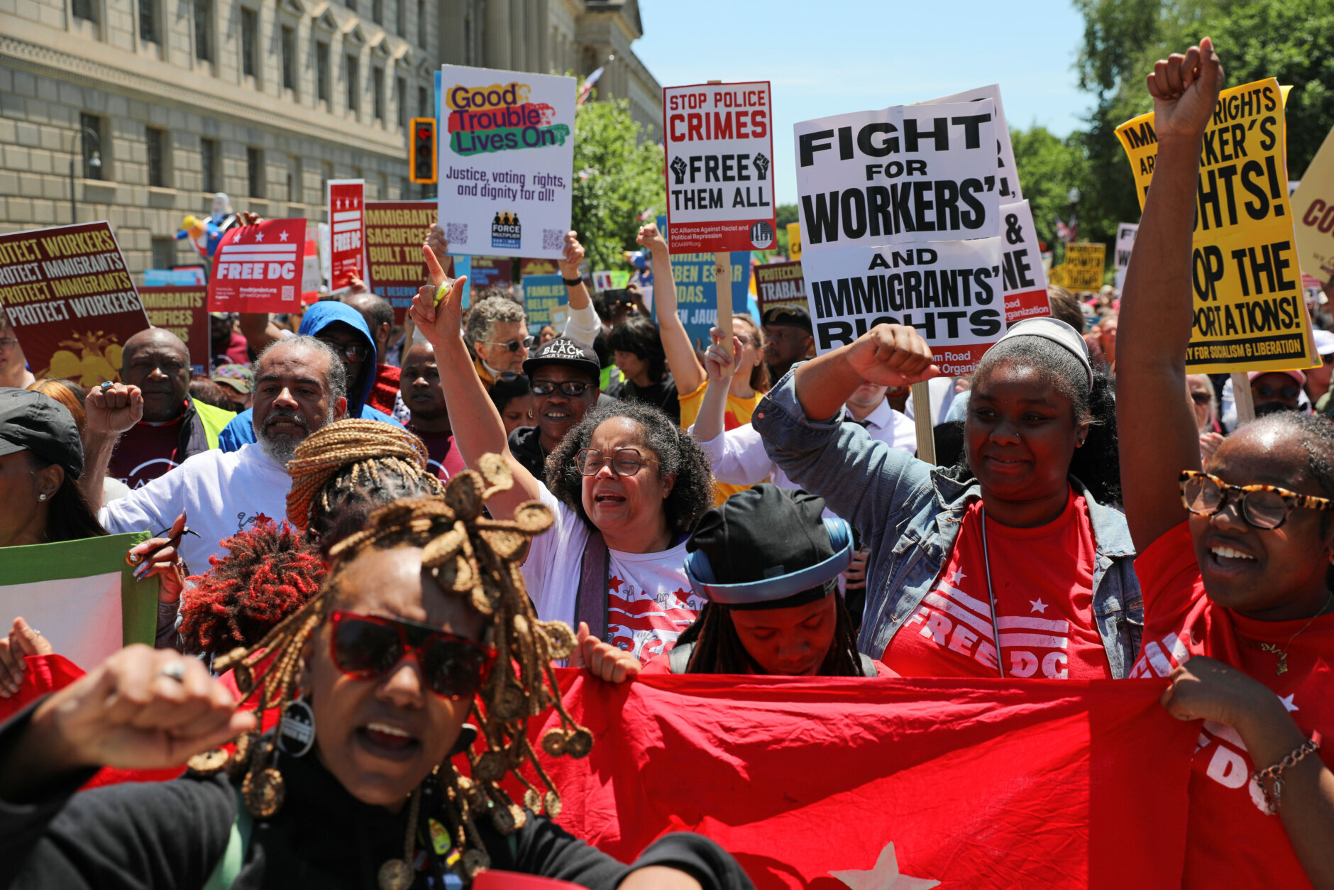 Demonstrators rally near the National Mall during a May Day protest Friday, May 1, 2026, in Washington. (AP Photo/Rahmat Gul)