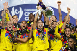 Scarlett Camberos of Mexico's America, center, lifts the trophy after winning the Women's CONCACAF Champions Cup final soccer match against The United States' Washington Spirit in Pachuca, Mexico, Saturday, May 23, 2026.(AP Photo/Fernando Llano)