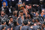 San Antonio Spurs forward Victor Wembanyama holds up the trophy