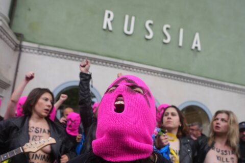 Protesters in pink balaclavas storm Russia’s pavilion at Venice Biennale and deploy colored smoke