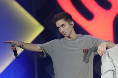 Ex-girlfriend of boy band member charged with trying to hire a hitman to kill him