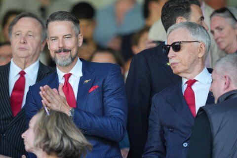 Kroenkes watch on as Arsenal’s players finally get their hands on the Premier League trophy