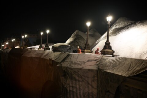 French artist JR begins his giant ‘cave’ art inflation over Paris’ oldest bridge