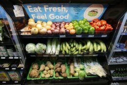 Bins of produce with a sign saying "Eat Fresh, Feel Good"