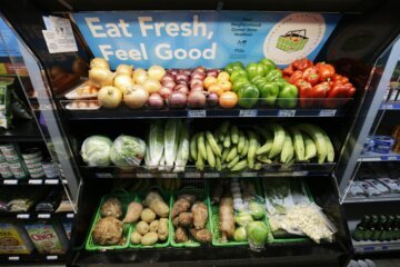 Bins of produce with a sign saying "Eat Fresh, Feel Good"