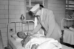 Gen. MacArthur pats the shoulder of Grover Wills