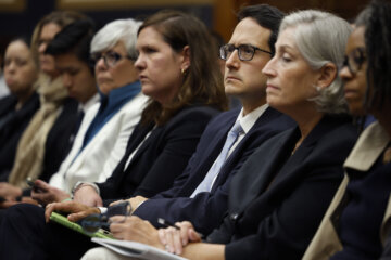 people dressed formally in hearing