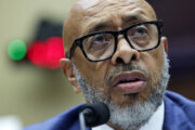 close up shot of man's face speaking into mic during testimony