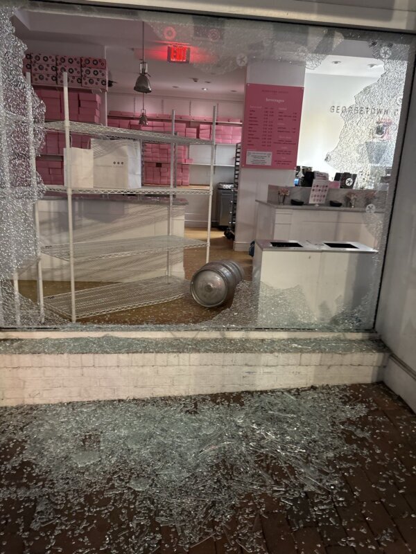 keg on ground of bakery with smashed glass around it