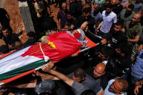 Palestinian man shot dead while climbing West Bank barrier into Israel in search of work