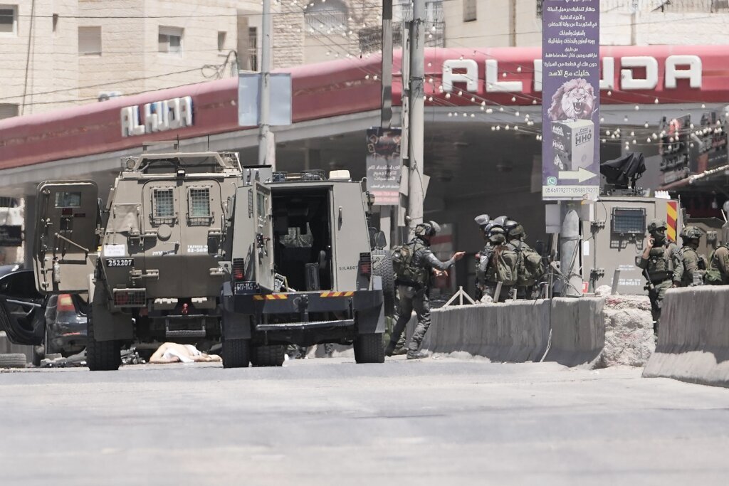 Israel’s military said a Palestinian family could bury their father. Then the settlers arrived
