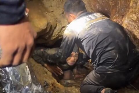 Rescuers search for alternative route to reach 2 missing in a flooded Laos cave