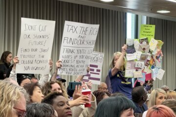 people holding signs