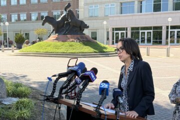 woman speaks into a microphone