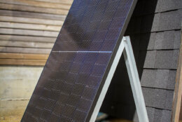A plug-in solar panel leaning on its frame.