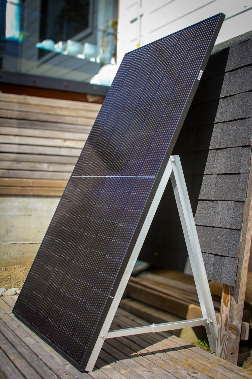 A plug-in solar panel leaning on its frame.