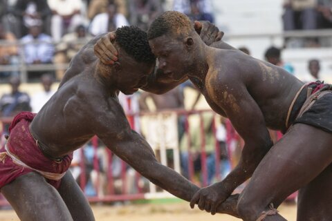 In Senegal’s wrestling arenas, rituals share the spotlight with the fight, in photos