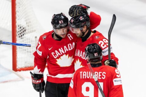 Canada beats Denmark and Crosby tallies 4 assists in third-period surge at hockey worlds
