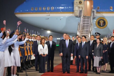 The Latest: Trump arrives in China to meet with Xi in Beijing