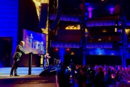 speaker on stage at award show in theatre