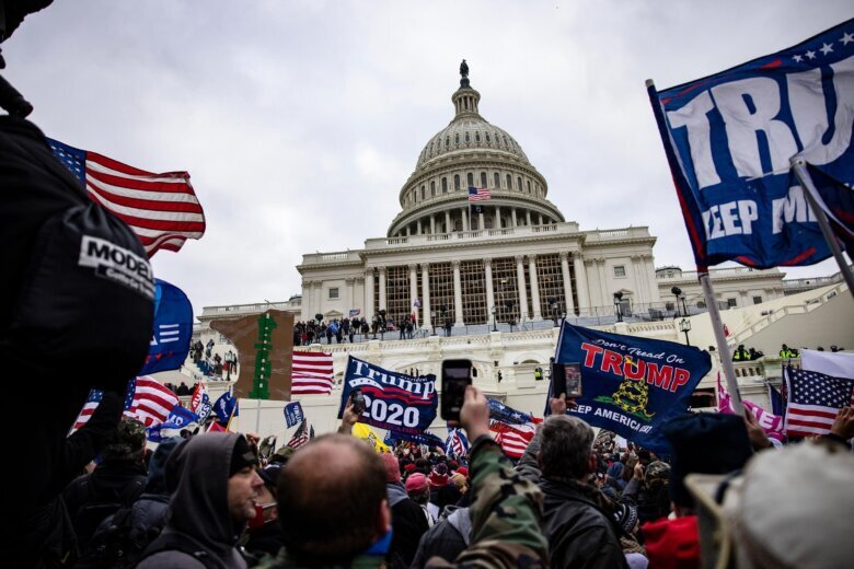 Pro-Trump supporters storm the US Capitol following a rally with President Donald Trump on January 6, 2021 in Washington, DC. Law enforcement officers who protected the US Capitol that day have sued the Trump administration to block implementation of a newly created $1.8 billion fund for allies of President Donald Trump who say they were unfairly investigated by previous administration.