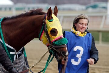 Groom Terry Overmeier leads Rapid Redux to the paddock for the start of the sixth race at Laurel Park where the horse won his 22nd consecutive victory on Jan. 4, 2012 in Laurel, Maryland. (Photo by Rob Carr/Getty Images)
